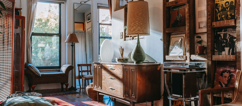 room with lots of different furniture and mid day sunlight coming in the window.